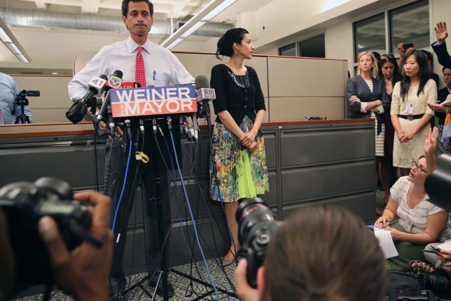 Barbara Morgan, to the right of the filing cabinet, looks at Anthony Weiner and Huma Abedin